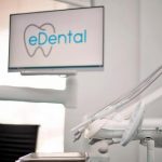 A flat-screen monitor that shows the logo of eDental Perth inside the clinic.