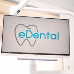 A widescreen monitor that shows the logo of eDental Perth inside the clinic.
