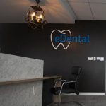 eDental Perth frontdesk office with chair and a wall painted in black with its logo on it.