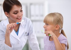 Nurse and a girl both holding a toothbrush and as the header image of 