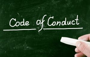 Code of Conduct chalk-written on a blockboard and as the header image of 