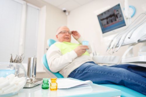 Male patient sitting on a dental chair and that represents the 