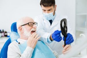 A patient checking his teeth along with Perth dentist, that represents the 