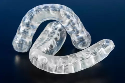 2 Pieces of dental/mouth splints that represent the 