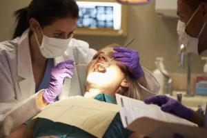 Dentist examining a patient which represents the 